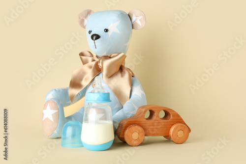 Teddy bear with bottle of m...