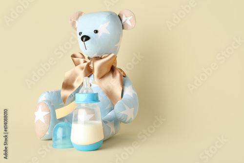 Teddy bear with bottle of m...