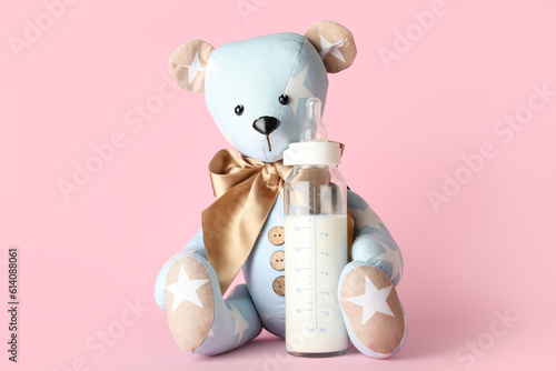 Teddy bear with bottle of m...