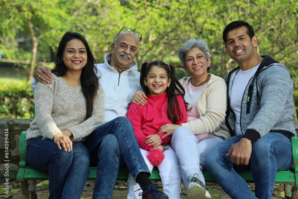 Fototapeta premium Happy Indian family with grandparents enjoying in the greenery