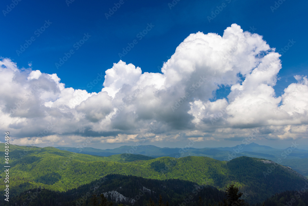 Large clouds above the forested mountains, Bijele stijene reserve in Croatia