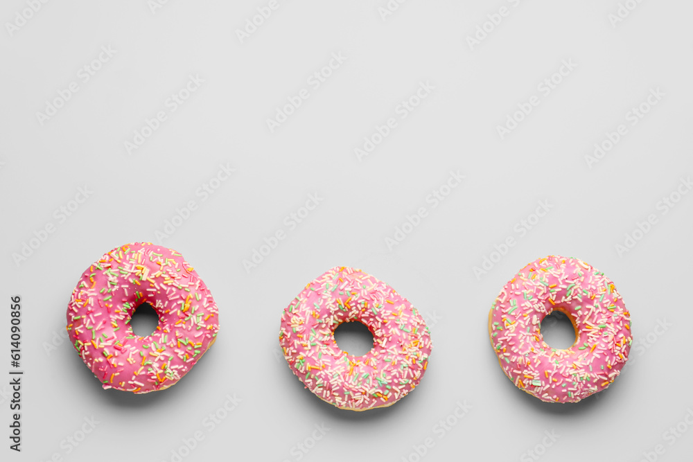 Sweet donuts on grey background Sweet donuts on grey background