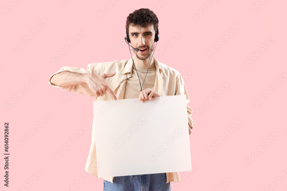 Male technical support agent with blank poster on pink background Male technical support agent with blank poster on pink background