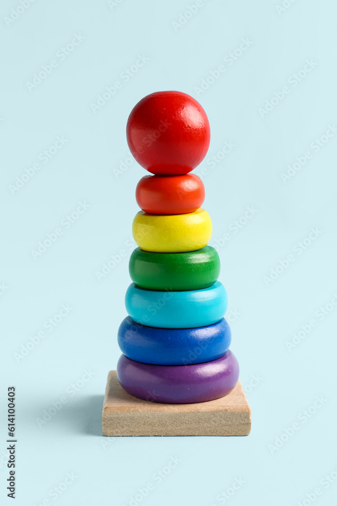 Wooden colorful toy pyramid on blue background. Children's Day celebration Wooden colorful toy pyramid on blue background. Children's Day celebration