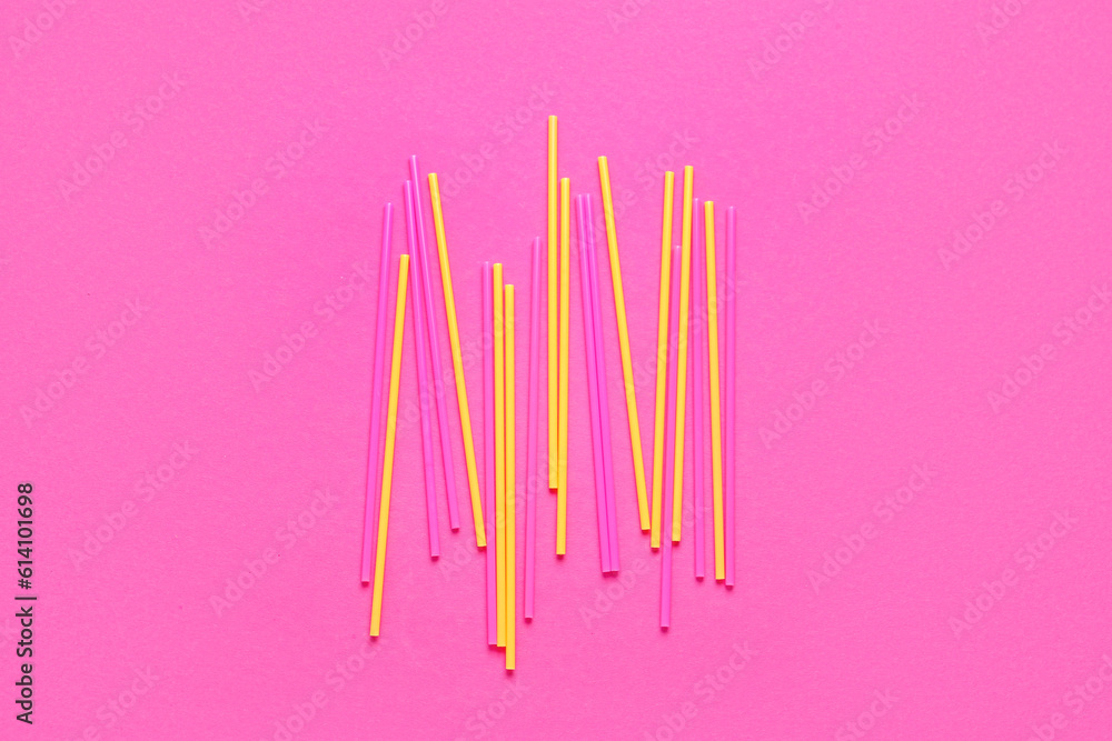 Different plastic straws on pink background Different plastic straws on pink background