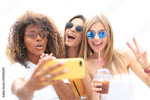 Three cute young girls friends having fun together, taking a selfie on a transparent background.