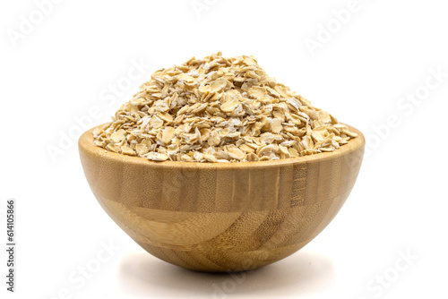Oatmeal or Oat flakes isolated on white background. Oatmeal in wooden bowl