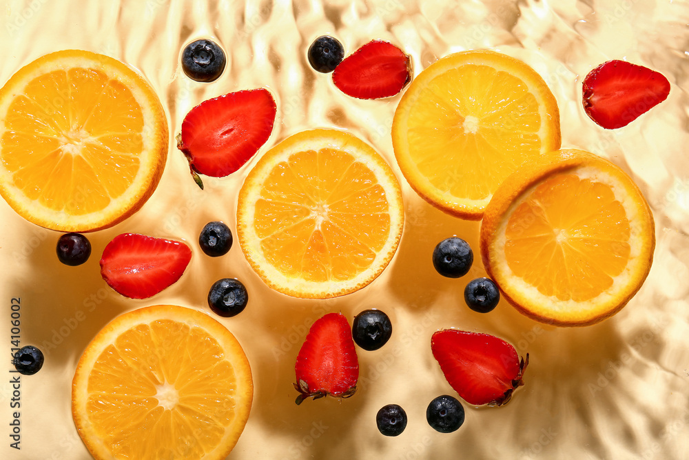 Different fruit slices in water on yellow background Different fruit slices in water on yellow background