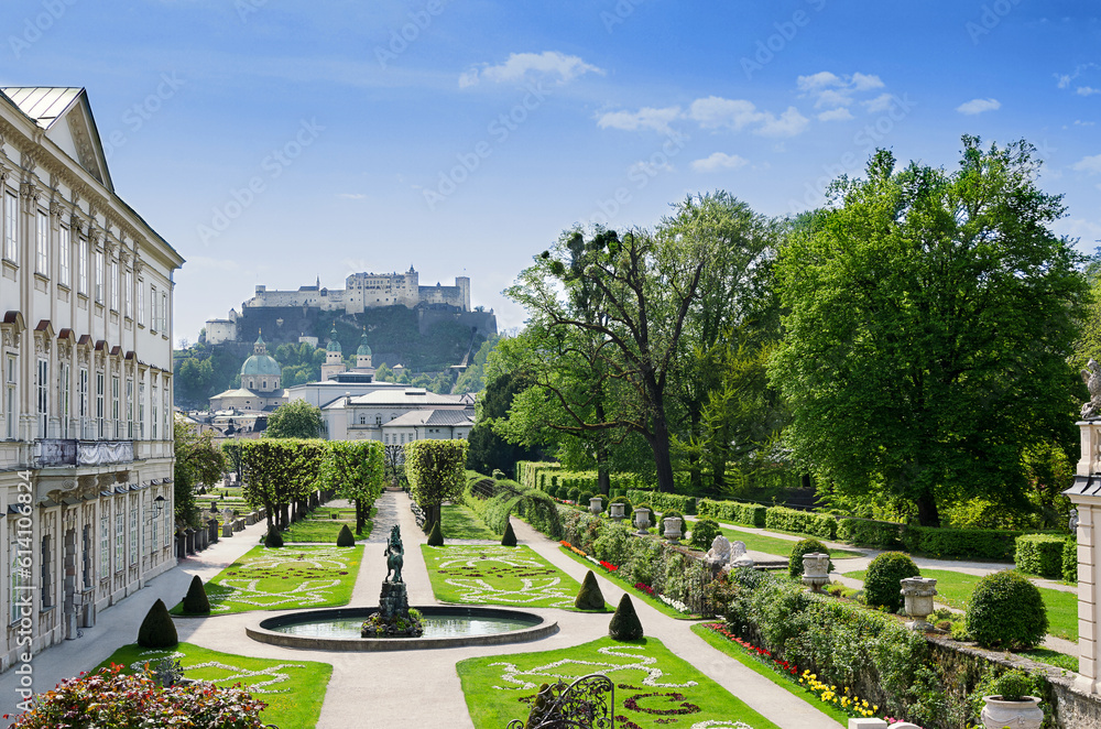 Naklejka premium Salzburg city in Austria, historic center with Baroque Mirabell Palace and Garden, and with Hohensalzburg Fortress in the distance, one of the largest fortress in Europe, dating from the 11th century.