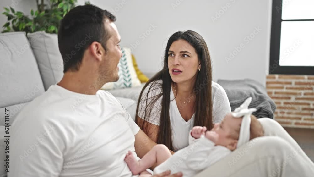 Family of three kissing sitting on the sofa at home Family of three kissing sitting on the sofa at home
