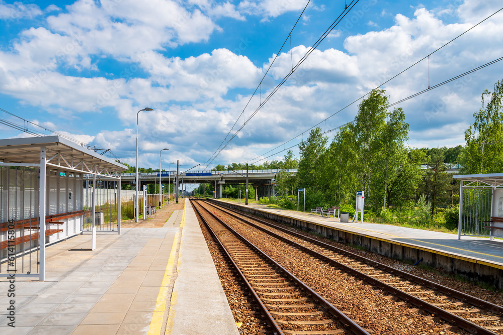 A small railway station. Car bridge in the background Railway and car transport. Sunny day