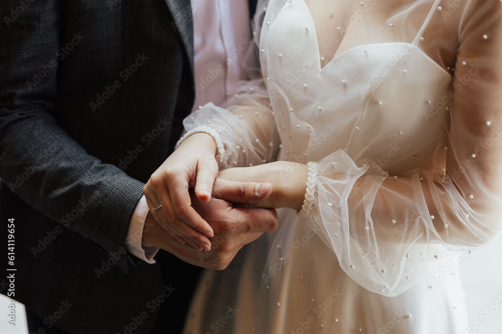 The young couple in love hold of hands. Close-up.