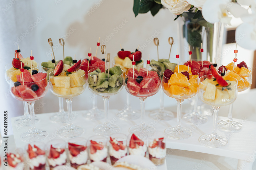Different fruits and berries in glasses. Catering on wedding. Sweet table with fruit, wedding catering. Fruit bar on party.