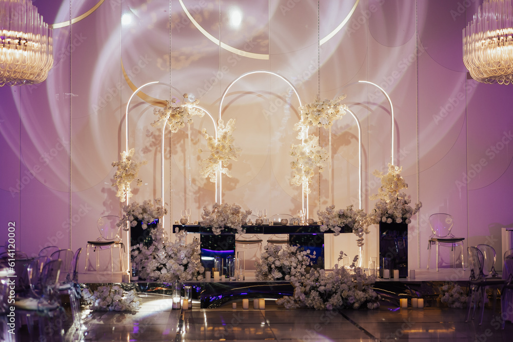 Wedding banquet decoration in delicate color. Classic, light and luxury wedding tables decorations, the festive table setting with candles.