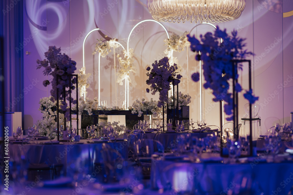 Wedding banquet decoration in delicate color. Classic, light and luxury wedding tables decorations, the festive table setting with candles.