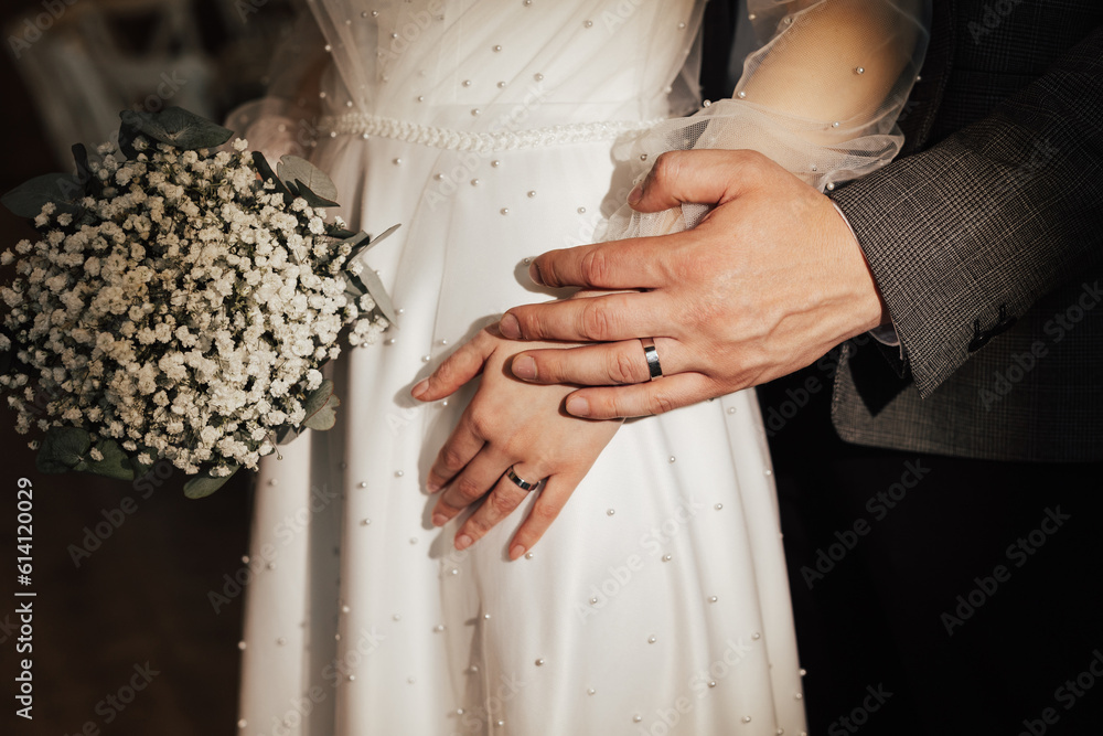 Cropped portrait of a loving couple hugging. Close up portrait of the charming newlyweds with rings on the fingers.