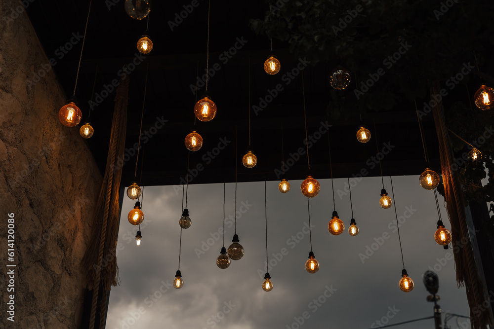 Set of vintage glowing light bulbs on cloudy sky background.Tungstens lights bulbs for inspiration or idea. Lights bulbs.