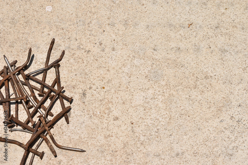 old rusty steel nails on cement background with copy space