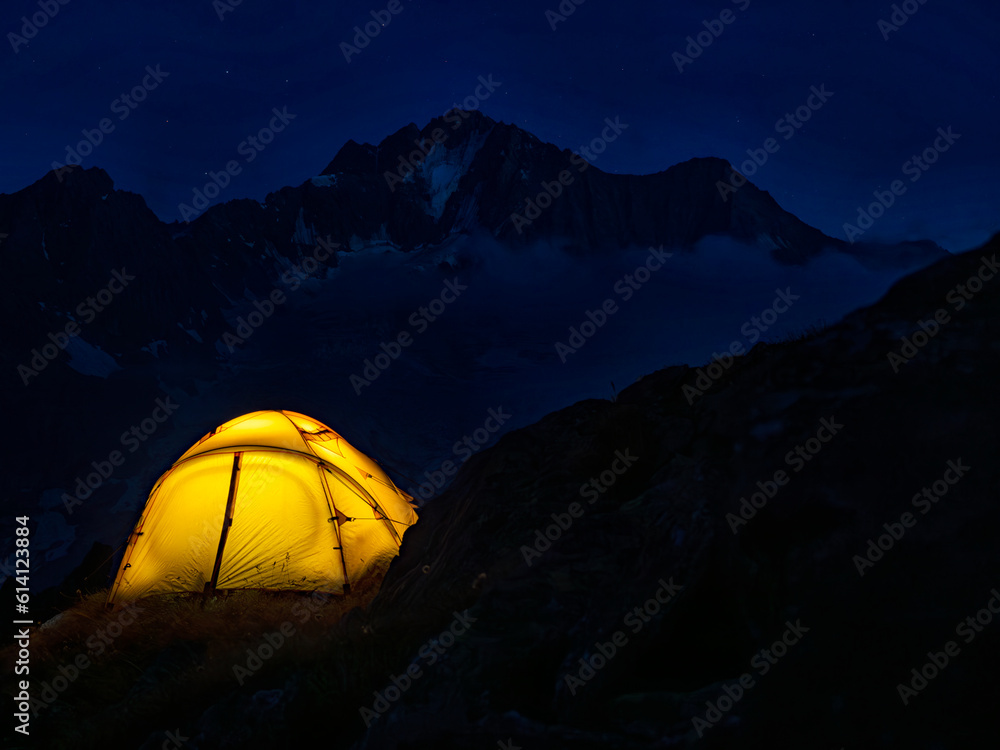 Camping tent at night in the Italian alps