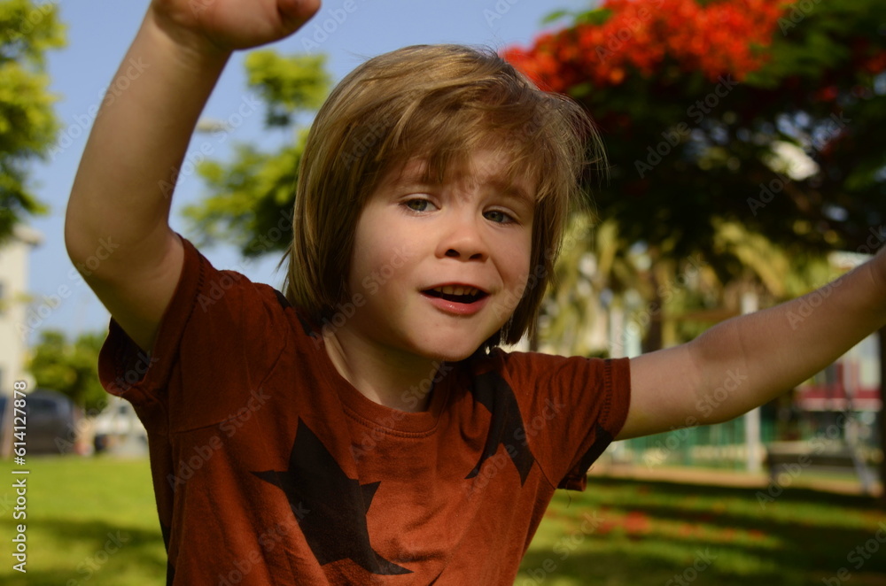 Preschooler on the playground. Summer, the boy walks on the street