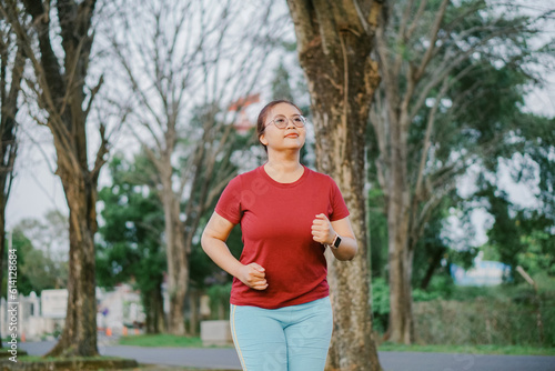 asian woman running and exercising outdoors excitedly