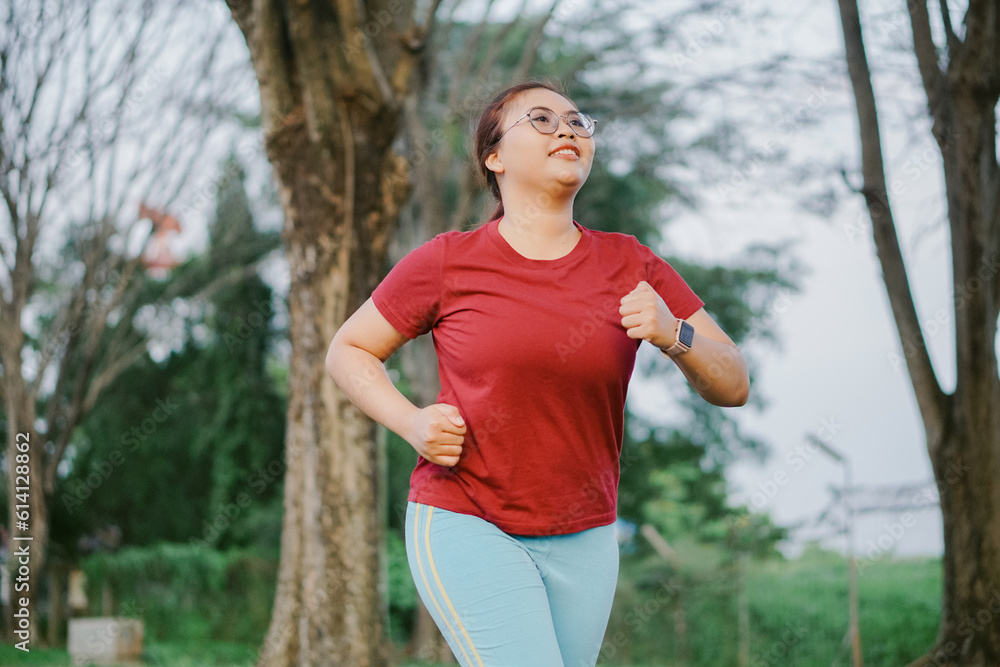 asian woman running and exercising outdoors excitedly