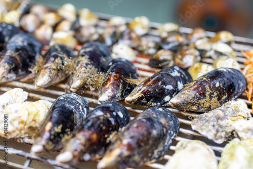 Fototapeta Naklejka Na Ścianę i Meble -  Mixed seafood barbecue on grill metal net
