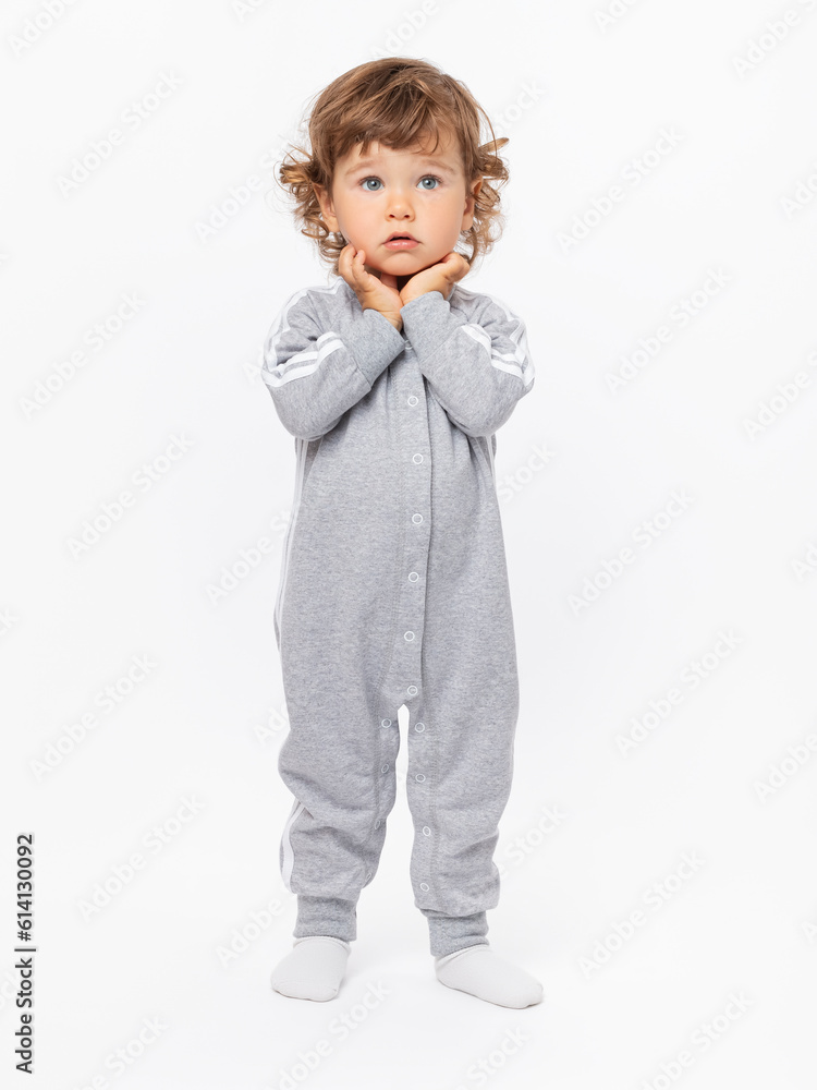 Surprise, question, fright. A 2-year-old boy looks expressively into the camera with his hands folded at his face on a white background. Surprise, question, fright. A 2-year-old boy looks expressively into the camera with his hands folded at his face on a white background.