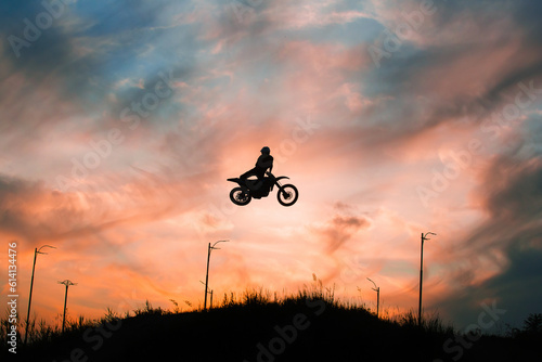 Fototapeta Naklejka Na Ścianę i Meble -  FMX rider performs dangerous stunts at sunset. Motocross.
