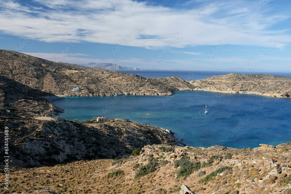 Panoramic view of the beautiful Tris klisies beach and a sailboat in Ios Greece