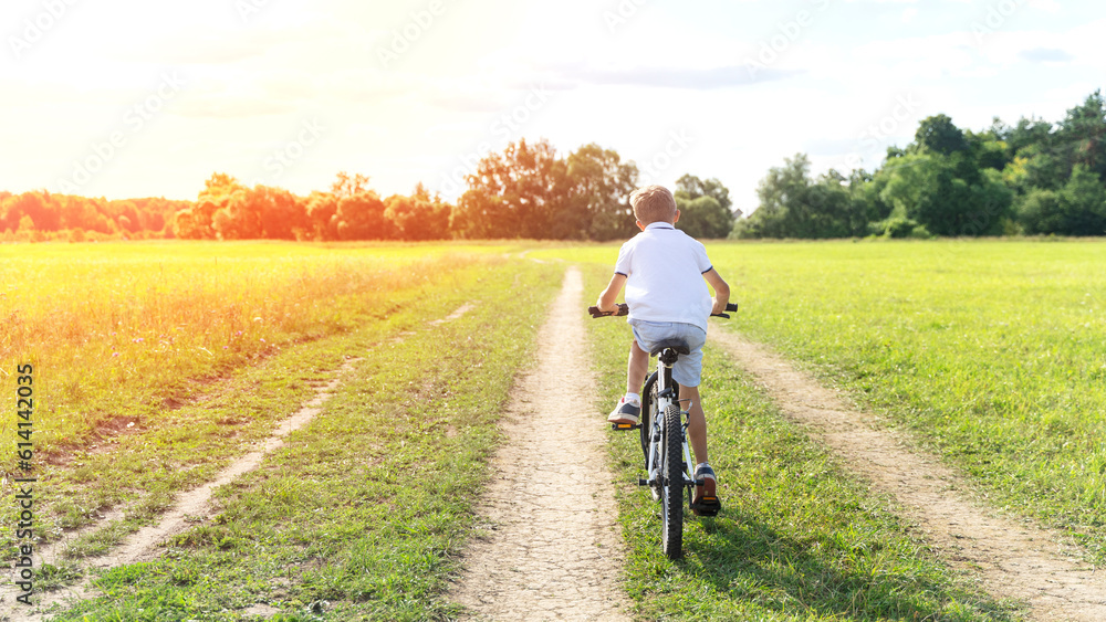 a boy rides a bicycle in nature a boy rides a bicycle in nature