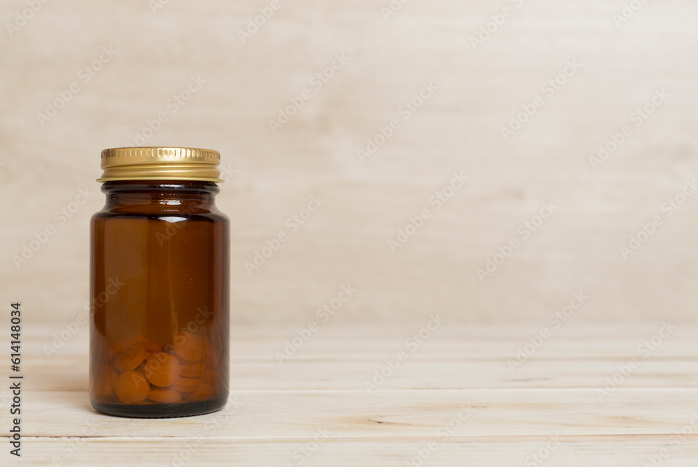 Plastic bottle for vitamins on wooden table Plastic bottle for vitamins on wooden table