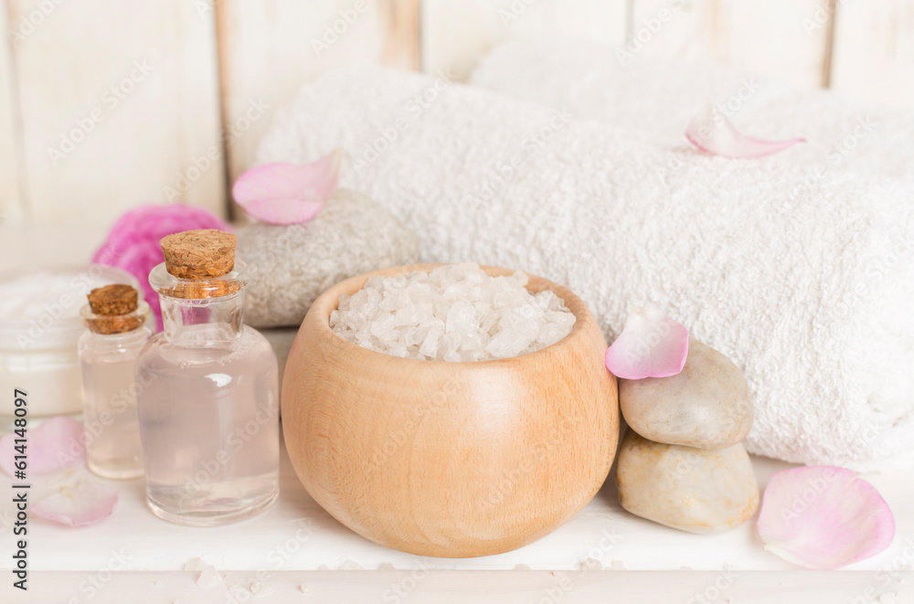 Spa composition with pink roses on wooden table