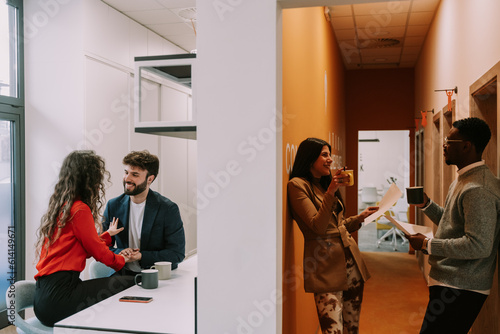 Принти на полотні Multicultural males flirting with their white female colleagues in a good atmosp
