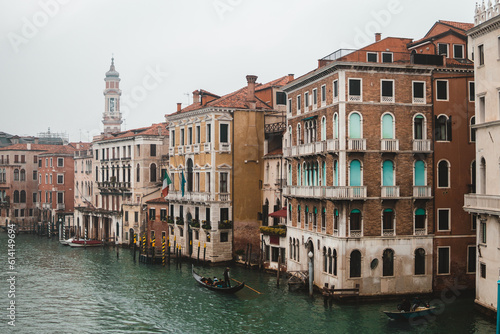 Venice's Grand Canal, veiled in morning mist from Rialto Bridge. A poetic scene blending ancient architecture with ethereal beauty.
