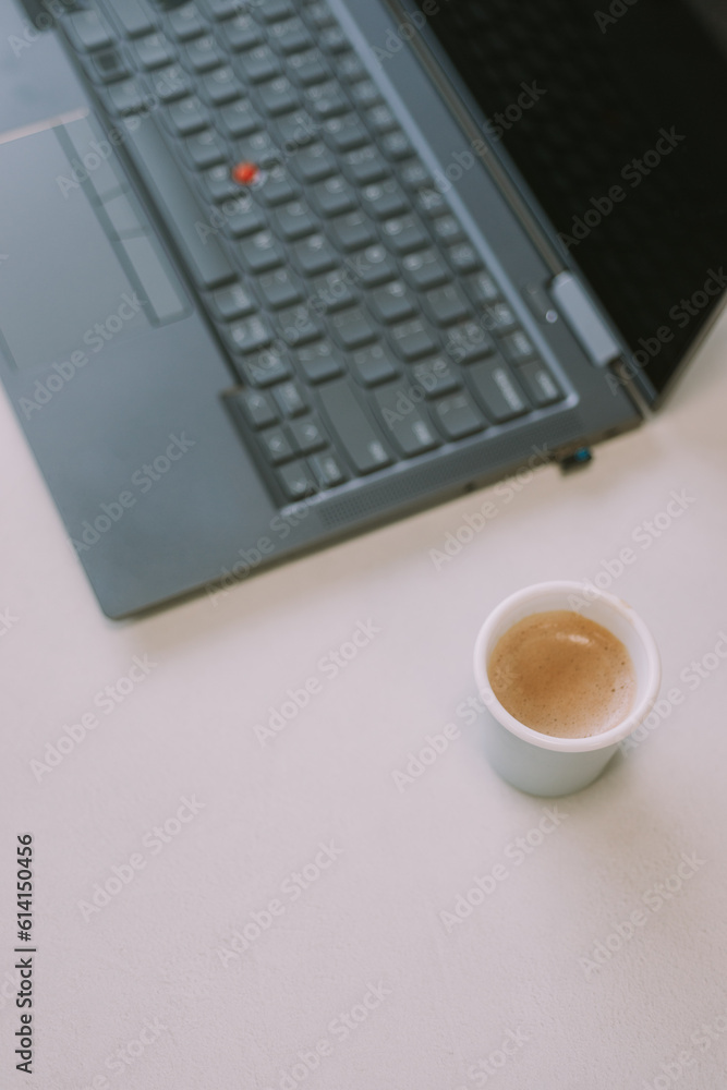 Close up of cup of coffee and laptop Close up of cup of coffee and laptop