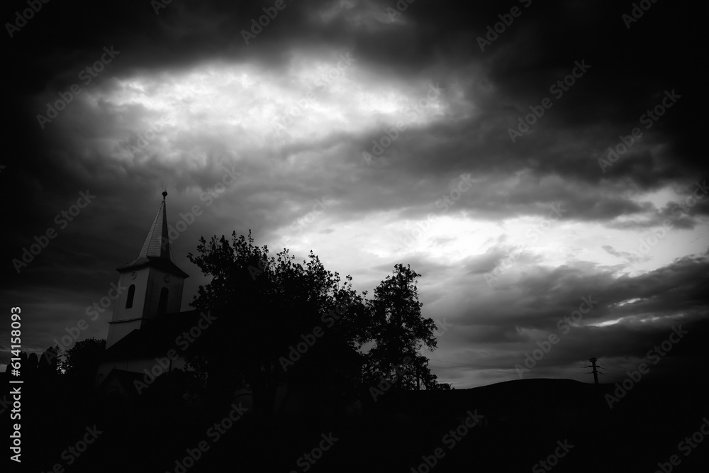 Chruch with dark, dramatic sky.