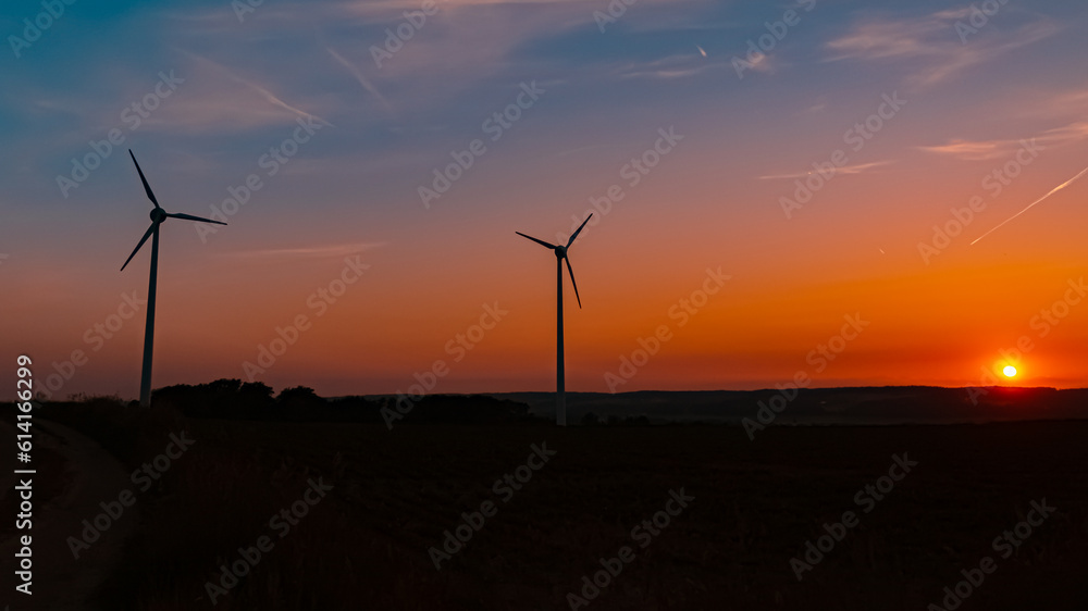 Sunset with wind power plant silhouettes near Kugl, Simbach, Dingolfing-Landau, Bavaria, Germany Sunset with wind power plant silhouettes near Kugl, Simbach, Dingolfing-Landau, Bavaria, Germany