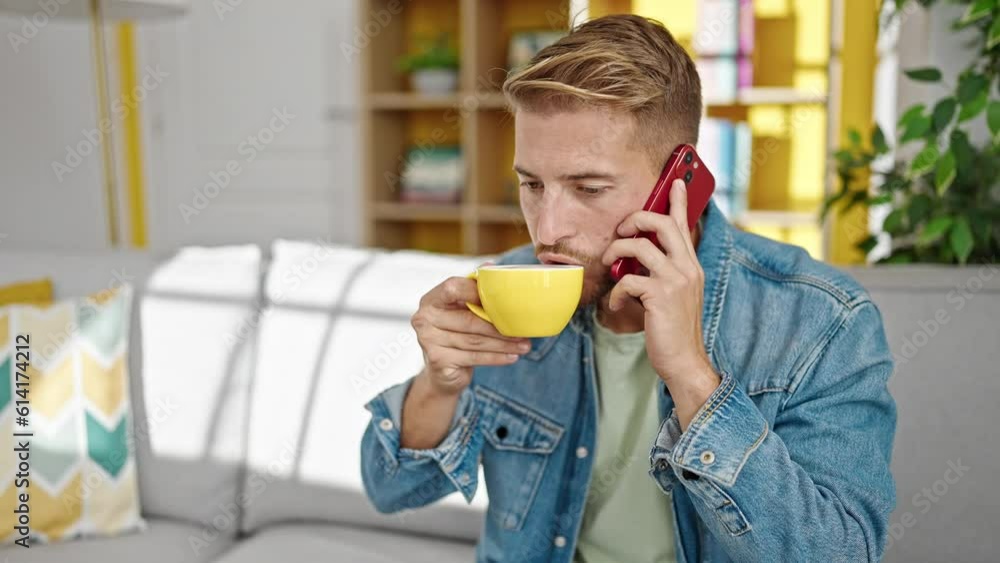 Young caucasian man talking on smartphone drinking coffee at home Young caucasian man talking on smartphone drinking coffee at home