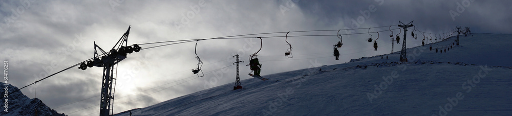 Panorama of the cable car with skiers in the Elbrus region