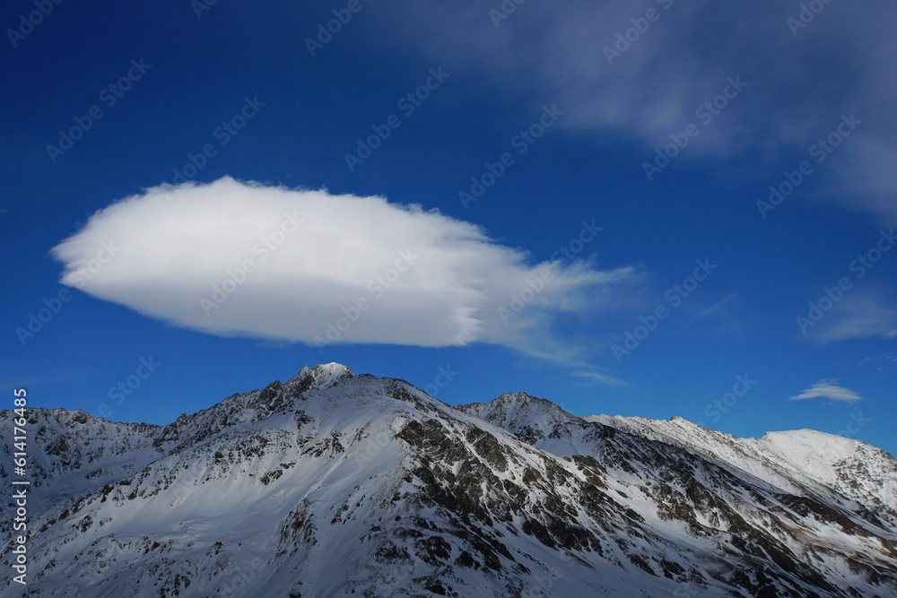 View of the mountain peaks with a cloud in the Caucasus