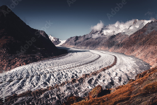 Alpine Aletsch Glacier viewpoint in Valais Canton, Switzerland, Europe. Trekking in Swiss Alps.