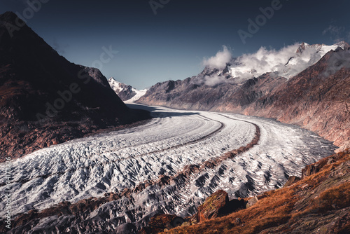 Alpine Aletsch Glacier viewpoint in Valais Canton, Switzerland, Europe. Trekking in Swiss Alps. photo