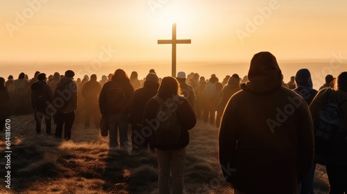 multitude of people looking towards a cross on the horizon