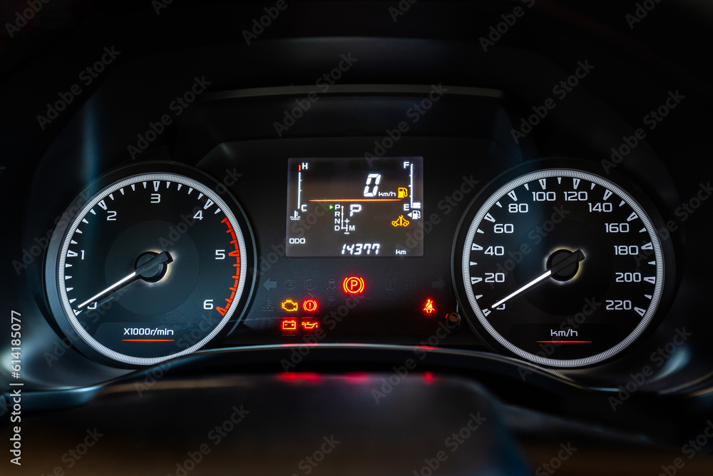 Modern car instrument dashboard panel with digital and analog screen or speedometer and symbol in night time