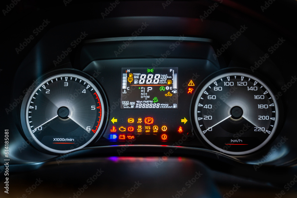 Modern car instrument dashboard panel with digital and analog screen or speedometer and full symbol in night time Modern car instrument dashboard panel with digital and analog screen or speedometer and full symbol in night time