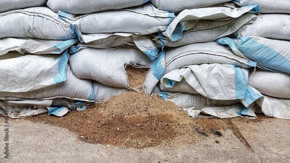Sand in plastic bag, stack of sand bag wall, water flood protection in