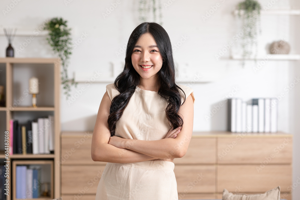 Stunning Beautiful Attractive Asian young woman standing looking at camera and smile happiness and comfortable at home.Cute girl smile cross arm smart confident and relax in living room at home Stunning Beautiful Attractive Asian young woman standing looking at camera and smile happiness and comfortable at home.Cute girl smile cross arm smart confident and relax in living room at home