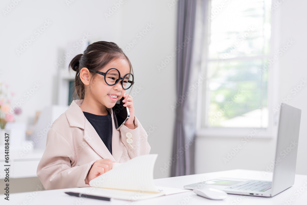 Little business lady Asia. formalwear sitting at the table and using laptop Little business lady Asia. formalwear sitting at the table and using laptop