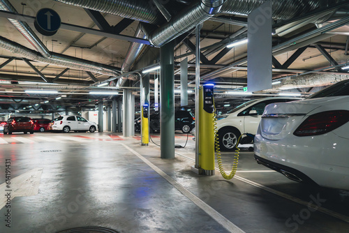 Electric cars are charged from the charging station in the indoor parking of the shopping center.